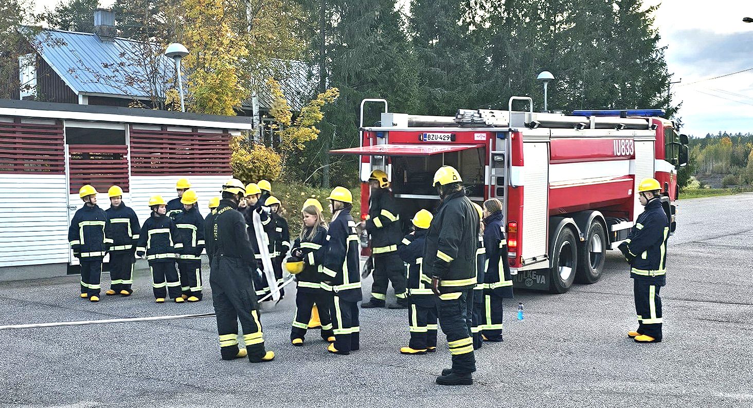 Askolan VPK:n nuoriso-osasto harjoittelemassa turvallisuusvarusteissa ulkona.